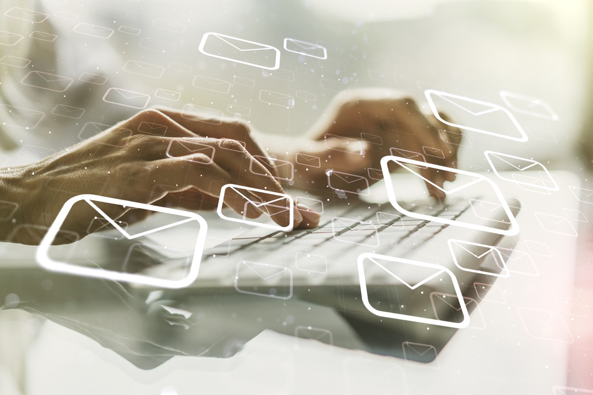 Abstract email envelope overlay on keyboard — representing digital business cards and vCard QR codes